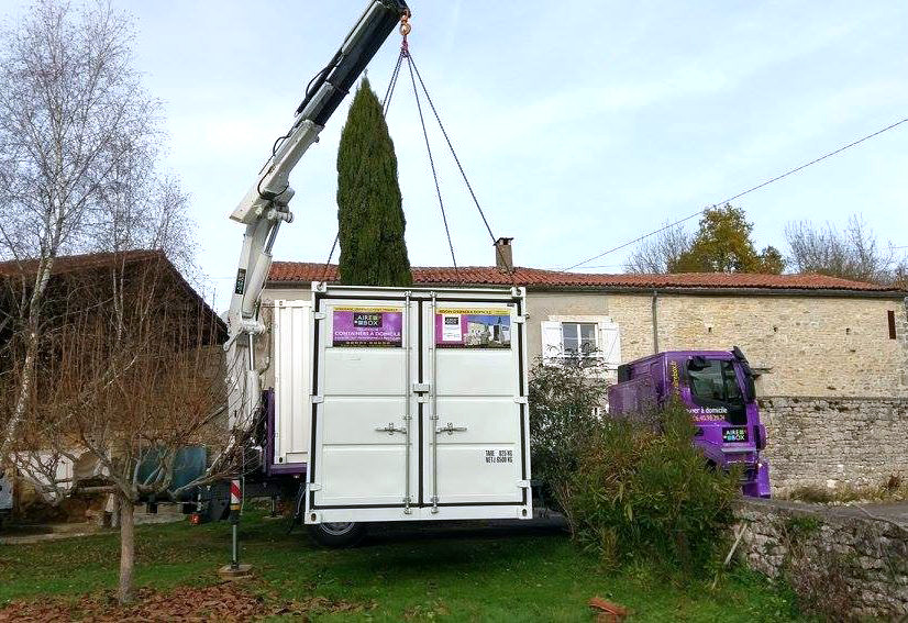 Camion porte container déposant un container à domicile